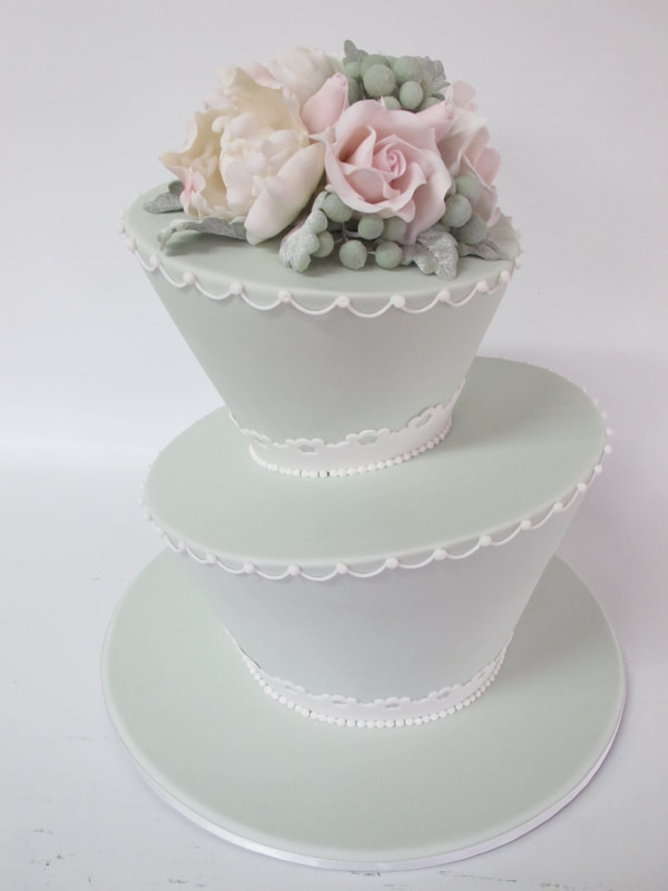 2 tier sage mad hatter wedding cake with sugar flowers