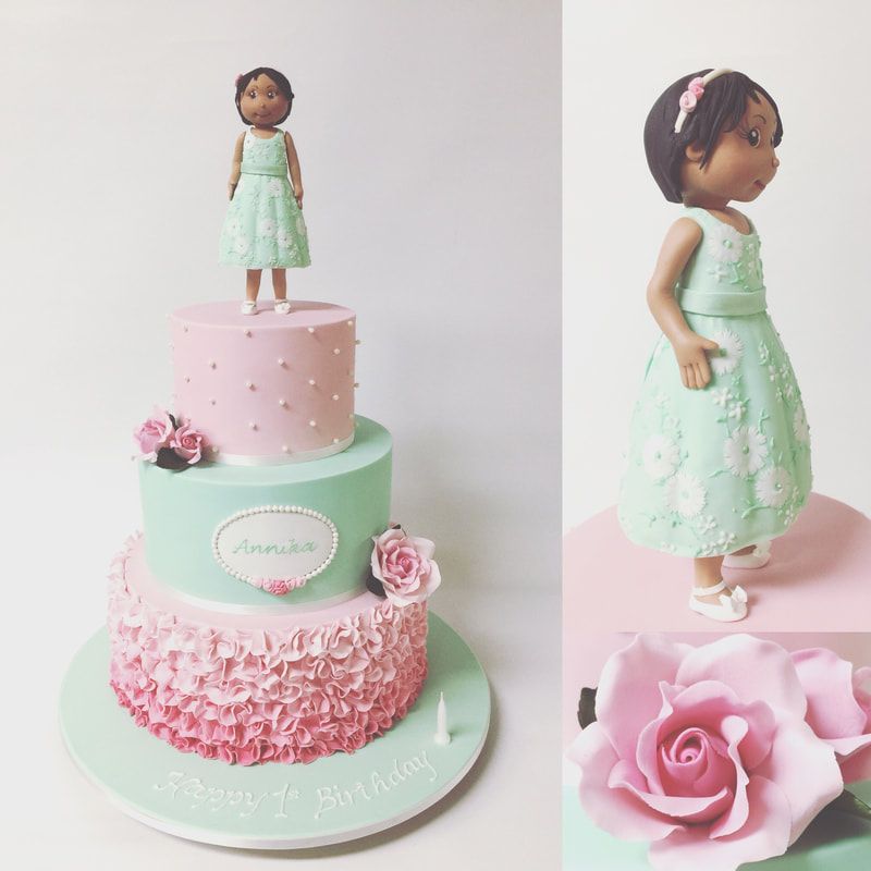 3 tier pink and aqua birthday cake with girl cake topper
