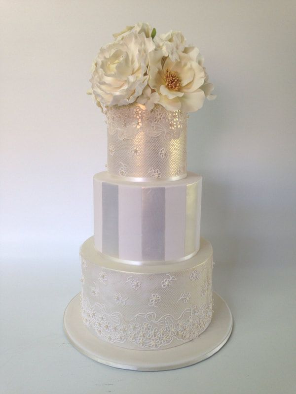 3 tier lace and stripe wedding cake with sugar flowers
