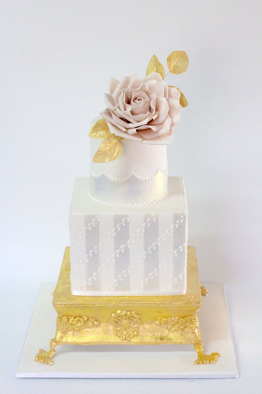 3 tier gold pedestal wedding cake