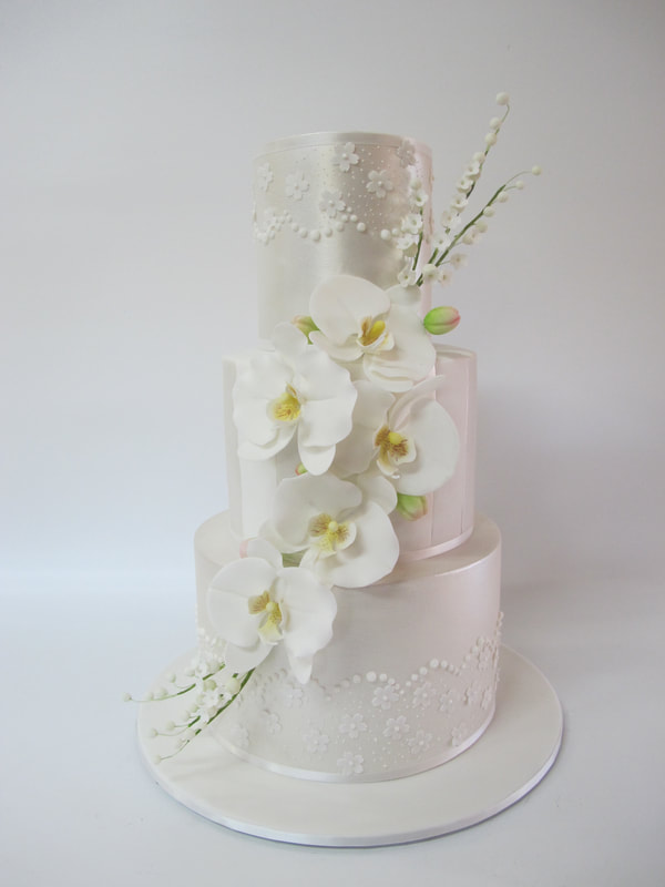 3 tier orchid and lily of valley weeding cake