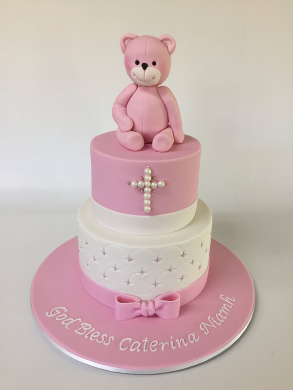 Pink christening cake with teddy topper