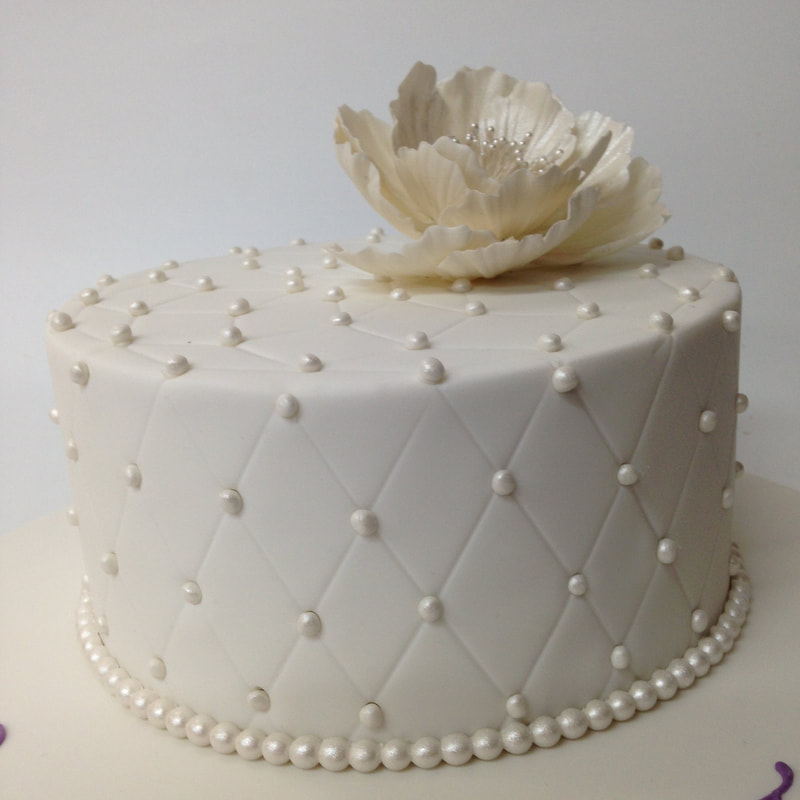 Quilted cake with pearls and sugar peony