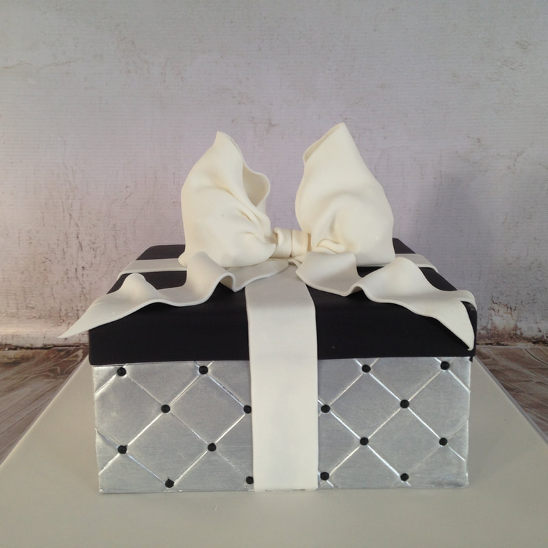 silver quilted present box cake